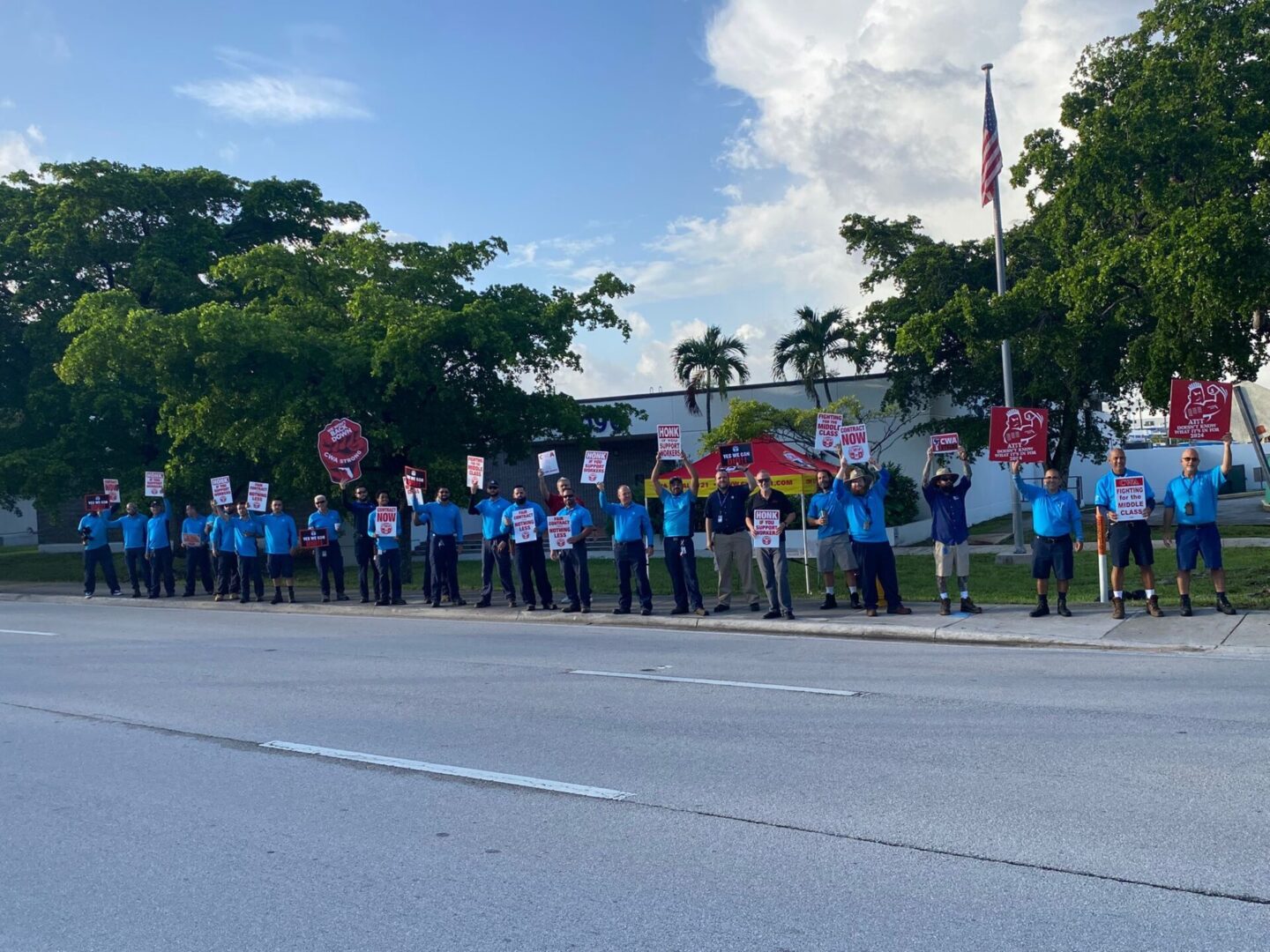 Union workers protest with signs.