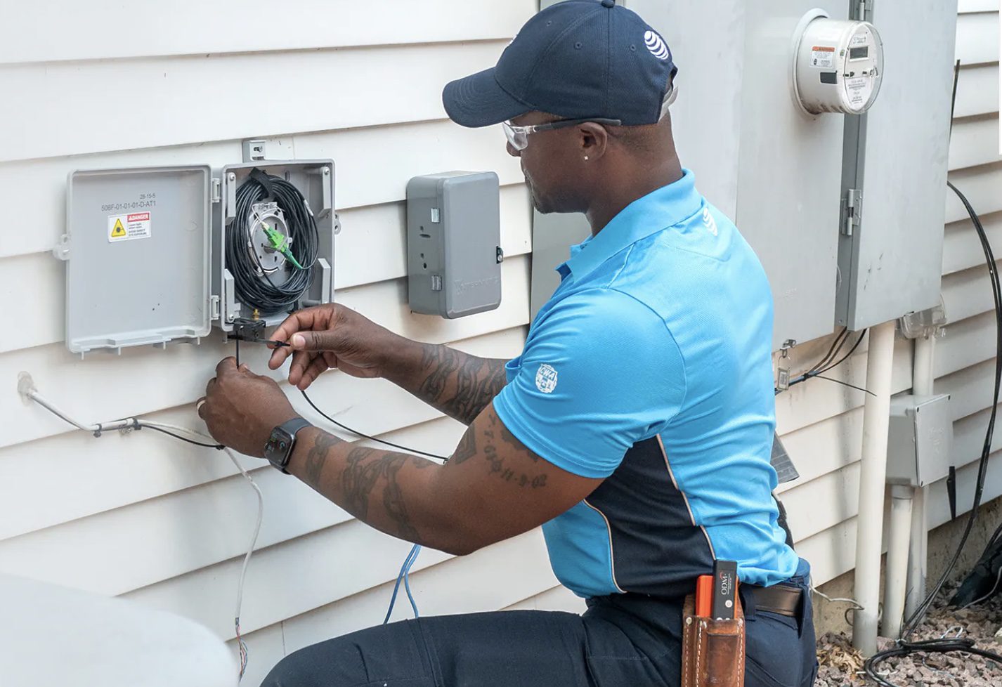 Technician installing outdoor network equipment.